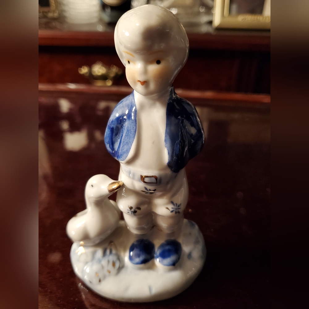 Charming Porcelain Figurine of Boy with Duck - Blue, white & gold.